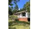 Charming single-story home with brick foundation and white siding, surrounded by lush greenery at 418 Cedar Grove Rd, Clover, SC 29710