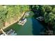 Aerial view of multiple docks with boats and waterfront properties surrounded by trees at 4218 Ash Hollow Ln, Denver, NC 28037