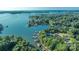 An aerial view displays the lake with lush greenery, showcasing several docks at 4218 Ash Hollow Ln, Denver, NC 28037