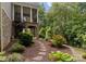 Lush backyard featuring a stone path, spiral staircase, and well-maintained landscaping at 4218 Ash Hollow Ln, Denver, NC 28037