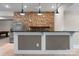 Basement bar with granite countertops, stainless steel refrigerator, and stone accent wall at 4218 Ash Hollow Ln, Denver, NC 28037