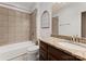 Well-lit bathroom showcases granite counters, a framed mirror, and a shower-tub combination at 4218 Ash Hollow Ln, Denver, NC 28037