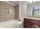 Full bathroom with a shower-tub combo, granite vanity, and tiled accents at 4218 Ash Hollow Ln, Denver, NC 28037