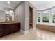 Spacious bathroom with a soaking tub, walk-in shower, vanity, and tiled floors at 4218 Ash Hollow Ln, Denver, NC 28037