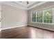 Light-filled bedroom with dark wood floors, neutral walls, and large windows providing ample natural light at 4218 Ash Hollow Ln, Denver, NC 28037