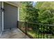 Outdoor deck area with wood railing overlooking a lawn and mature trees at 4218 Ash Hollow Ln, Denver, NC 28037
