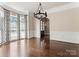 Elegant dining room with dark hardwood floors, stylish chandelier, and bright bay windows at 4218 Ash Hollow Ln, Denver, NC 28037