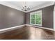 Classic dining room with a chandelier, hardwood floors, and a window at 4218 Ash Hollow Ln, Denver, NC 28037
