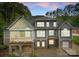 Beautiful multi-story home with large windows, stone accents, and back patio at 4218 Ash Hollow Ln, Denver, NC 28037