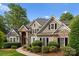 Charming two-story home with stone accents, dark shutters, and well-manicured landscaping at 4218 Ash Hollow Ln, Denver, NC 28037