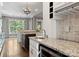 Kitchen featuring granite countertops, wine cooler, stainless steel faucet and view to the dining room at 4218 Ash Hollow Ln, Denver, NC 28037