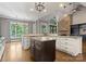 Spacious kitchen with an island, granite countertops, stone fireplace, and abundant natural light at 4218 Ash Hollow Ln, Denver, NC 28037