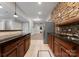 Modern kitchen featuring granite countertops, stainless steel appliances, and stone accent wall at 4218 Ash Hollow Ln, Denver, NC 28037