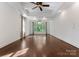 Bright living room features hardwood floors, a ceiling fan, and a large bay window at 4218 Ash Hollow Ln, Denver, NC 28037