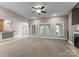 Spacious living area with fireplace, plush carpet, natural light, and seamless flow to other spaces at 4218 Ash Hollow Ln, Denver, NC 28037