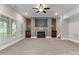 Inviting living room featuring a brick fireplace, carpet, ceiling fan, and windows for natural light at 4218 Ash Hollow Ln, Denver, NC 28037