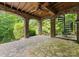 Stone patio with an arched ceiling, wooden beams, and an outdoor spiral staircase at 4218 Ash Hollow Ln, Denver, NC 28037