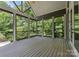 Inviting covered porch featuring sturdy columns, wooden floors, and scenic wooded views at 4218 Ash Hollow Ln, Denver, NC 28037