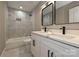 Elegant bathroom featuring a tiled shower-tub and a dual vanity with black fixtures at 446 Mint St, Rock Hill, SC 29730