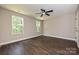 Bright bedroom with hardwood floors, a ceiling fan, and two large windows at 446 Mint St, Rock Hill, SC 29730