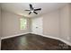 Bright bedroom with a ceiling fan, hardwood floors, closet, and a window at 446 Mint St, Rock Hill, SC 29730