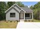Charming single-story home featuring gray siding, black window trim and concrete driveway at 446 Mint St, Rock Hill, SC 29730