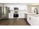 Modern kitchen features white cabinets, stainless steel appliances and hardwood floors at 446 Mint St, Rock Hill, SC 29730