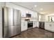 Well-lit kitchen with white cabinets, stainless appliances and hardwood floors at 446 Mint St, Rock Hill, SC 29730