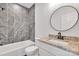 Cozy bathroom featuring a shower/tub, granite countertops, and a modern round mirror at 516 North Mulberry St, Cherryville, NC 28021