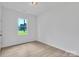 Bright bedroom with a large window and neutral walls maximizing natural light and showcasing the wood-look floors at 516 North Mulberry St, Cherryville, NC 28021