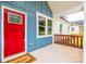 Charming covered front porch with blue siding and a bright red door at 516 North Mulberry St, Cherryville, NC 28021