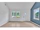Bright living room with large windows, a modern front door and neutral walls showcasing the natural light and wood-look floors at 516 North Mulberry St, Cherryville, NC 28021