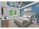 Relaxing main bedroom featuring a tray ceiling, ample natural light, and calming blue accent wall at 516 North Mulberry St, Cherryville, NC 28021