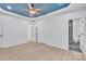Spacious main bedroom featuring recessed lighting, tray ceilings, and a ceiling fan, with a view to a modern en-suite bathroom at 516 North Mulberry St, Cherryville, NC 28021