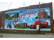 A bright and historic mural with local historical imagery at 516 North Mulberry St, Cherryville, NC 28021