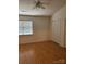 Well-lit bedroom with a ceiling fan, window, and double closet doors, offering ample storage at 5650 Kimmerly Woods Dr, Charlotte, NC 28215