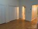 Bright and airy bedroom featuring hardwood floors, a closet, and natural light from the windows at 5650 Kimmerly Woods Dr, Charlotte, NC 28215