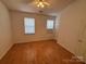 Bedroom with hardwood floors, neutral walls, and two windows for natural light at 5650 Kimmerly Woods Dr, Charlotte, NC 28215