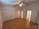 Bedroom with hardwood floors, ample closet space, and easy access to the hallway at 5650 Kimmerly Woods Dr, Charlotte, NC 28215
