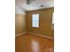 Cozy bedroom with hardwood floors, neutral walls, and bright windows at 5650 Kimmerly Woods Dr, Charlotte, NC 28215