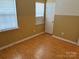 Cozy bedroom with hardwood floors, neutral walls, and a window at 5650 Kimmerly Woods Dr, Charlotte, NC 28215