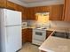 Well-lit kitchen with white appliances, ample countertop space, and oak cabinets at 5650 Kimmerly Woods Dr, Charlotte, NC 28215