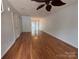 Hardwood floors in a living room with ceiling fan and view to backyard at 5650 Kimmerly Woods Dr, Charlotte, NC 28215