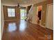 Cozy living room with laminate flooring, ceiling fan, and staircase at 5650 Kimmerly Woods Dr, Charlotte, NC 28215