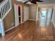 Open-concept living space with laminate floors and view to kitchen at 5650 Kimmerly Woods Dr, Charlotte, NC 28215