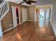 Spacious living room with laminate floors, ceiling fan and staircase at 5650 Kimmerly Woods Dr, Charlotte, NC 28215
