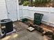 View of the patio area featuring privacy fence, an AC unit, and green space at 5650 Kimmerly Woods Dr, Charlotte, NC 28215