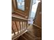 Carpeted staircase with white banister leading to the front door and entryway of the home at 5650 Kimmerly Woods Dr, Charlotte, NC 28215