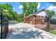 Brick home featuring a large concrete and brick paved backyard with fenced gate at 5720 Amity Pl, Charlotte, NC 28212