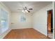 Cozy bedroom with gleaming hardwood floors and a ceiling fan, creating a comfortable retreat for rest and relaxation at 5720 Amity Pl, Charlotte, NC 28212